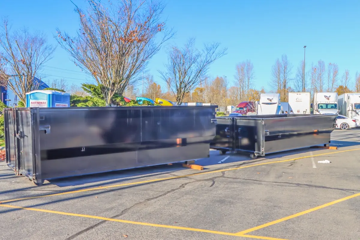 Professional dumpster rental service with roll-off container on residential driveway in Palm Valley